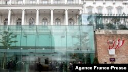 People walk outside The Hotel Palais Coburg, where talks resumed on reviving the 2015 Iran nuclear deal - the Joint Comprehensive Plan of Action (JCPOA) - in Vienna, Dec. 27, 2021.