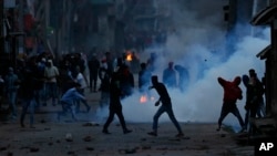 Kashmiri protesters throw stones on government forces during a protest in Srinagar, Indian controlled Kashmir, May 7, 2018.