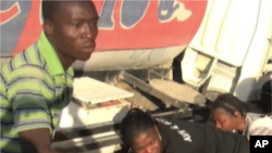 Residents in Port-au-Prince get fresh water from a truck.