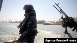 FILE - Ukrainian border guards patrol the Sea of Azov off the city of Mariupol, April 30, 2021. A Russian official falsely claimed the sea to be "Russia's internal waters."