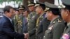 Thai Defense Minister General Yuthasak Sasiprapa, left, shakes hands with Cambodia's internal-security chief Sao Sokha, right, upon his arrival at the Ministry of Defense in Phnom Penh on Sept. 23, 2011.