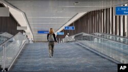 A concourse at Sky Harbor Airport is unusually empty as airlines cut flights due to the coronavirus outbreak, March 17, 2020, in Phoenix.