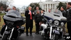 President Donald Trump give a 'thumbs-up' as he meets with Harley Davidson executives and union representatives on the South Lawn of the White House in Washington, Thursday, Feb. 2, 2017.