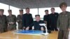 North Korean leader Kim Jong Un (center) inspects a long and medium-range ballistic rocket launch in this undated photo released by North Korea's Korean Central News Agency in Pyongyang on Aug. 30, 2017.