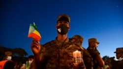 FILE - Current and former Ethiopian military personnel and the public commemorate federal soldiers killed by forces loyal to the Tigray People's Liberation Front at the start of the conflict one year ago, at a candlelit event outside the city administrati