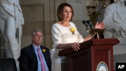 Speaker of the House Nancy Pelosi, D-Calif., and House Republican Leader Kevin McCarthy, D-Calif., left, appear together at an event to commemorate the 100th anniversary of the 19th Amendment in Washington, Tuesday, May 21, 2019.