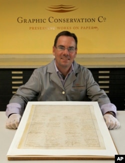 Russ Maki, president of Graphic Conservation Company displays a rare copy of the 13th Amendment that ended slavery in this 2011 file photo.