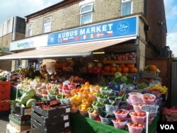 A shop in Peterborough's Millfield neighborhood reflects the city's diversity. The English city has a long tradition of welcoming immigrants. In the Millfiels neighborhood, English is not often heard and store signs are written in Dari, Pashto, Arabic, Polish and Hungarian. (L. Ramirez/VOA)