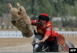 A Kyrgyz rider plays the traditional Central Asian sport Buzkashi also known as Kok-Boru or Oglak Tartis