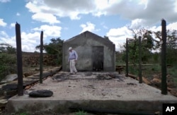 Farmer Martin Evans inspects a blackened home, burned down during an invasion by semi-nomadic herders on his property in Laikipia, Kenya, July 27, 2017.