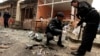 Policemen collect evidence from the site of a bomb attack at the district court in Islamabad, Pakistan, Mar. 3, 2014. 