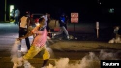 Namoyishchilar favqulodda holat e'lon qilinganiga qaramay, ko'chalarni tark etmayapti, Ferguson, 17-avgust, 2014-yil. 