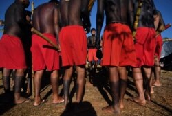 Indigenous men from the Krenak tribe perform a ceremony at a protest camp in Brasilia, Brazil on Aug. 23, 2021.