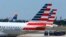 FILE - American Airlines planes wait on the tarmac at Washington's Reagan National Airport.