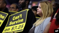 FILE - U.S. workers participates in a rally in support of raising the minimum wage University City, Missouri.