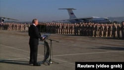 Russian President Vladimir Putin speaks to Russian forces on surprise visit to Russia's Hmeymim air base in Syria's Latakia Province on December 11, 2017.