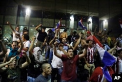 FILE - Protesters chant slogans against presidential re-elections outside the congress building, in Asuncion, Paraguay, March 31, 2017.