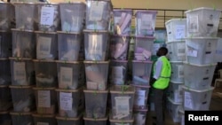 An IEBC official inspects ballot boxes at Kasarani gymnasium, Nairobi, March 5, 2013.