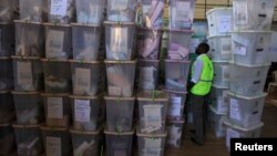 An IEBC official inspects ballot boxes at Kasarani gymnasium, Nairobi, March 5, 2013.