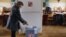 A woman casts her ballot during the country's first-ever direct presidential election to replace the outgoing president Vaclav Klaus, in Prague January 11, 2013.