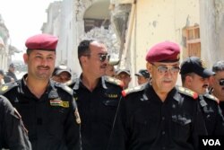 Major Assad al-Assadi, left, and Lt. General Abdul Ghani al-Assadi of Iraqi Special Forces, or the Golden Division, tour areas of the Old City they captured in recent days, now abandoned and in ruins. June 22, 2017, in Mosul, Iraq. (H. Murdock/VOA)