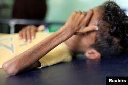 Malnourished Ghazi Ahmad, 10, lies on a bed at a hospital in Taiz, Yemen, Oct. 30, 2018.