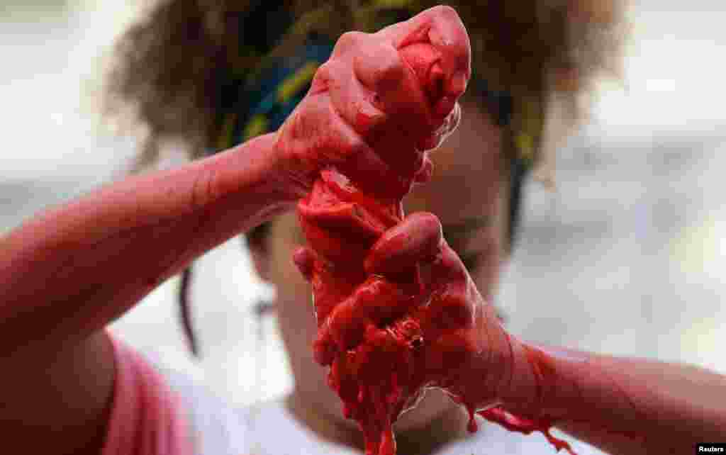 Activist from NGO Rio de Paz (Peace Rio) Thais Ferreira da Silva, representing the late activist and councilwoman Marielle Franco, performs in front of an empty jail to mark the first year of Franco&#39;s murder, in downtown Rio de Janeiro, Brazil.