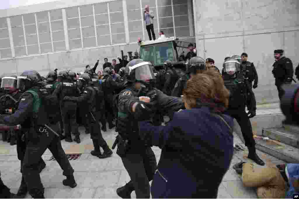 Civil guards clear people away from the entrance of a sports center, assigned to be a polling station by the Catalan government in Sant Julia de Ramis, near Girona, Oct. 1, 2017.