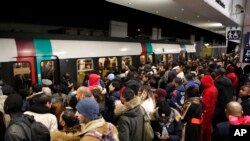 Commuters wait to catch a subway train Tuesday, Dec. 10, 2019 in Paris. Only about a fifth of French trains ran normally Tuesday, frustrating tourists finding empty train stations, and most Paris subways were at a halt.