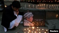 Afghan men light candles for Japanese Dr. Tetsu Nakamura, who was killed in Jalalabad in a terrorist attack, in Kabul, Afghanistan, Dec. 5, 2019.