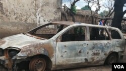 FILE - A burnt motor viehicle is seen following post-election violence in Lilongwe, Oct. 8, 2019. (Lameck Masina/VOA)