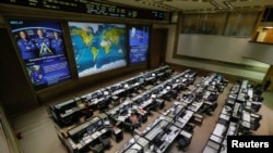 Photo of International Space Station (ISS) crew members Serena Aunon-Chancellor of the U.S., Alexander Gerst of Germany and Sergey Prokopyev of Russia is seen in the Russian Mission Control Center before a news conference on the results of the investigation on the failed Soyuz rocket launch on Oct. 11, in Korolev, outside Moscow, Russia, Nov. 1, 2018. 