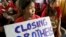 A Cambodian sex worker, center, holds a banner read " Closing Brothels" in a conference room for protest in Phnom Penh, Cambodia, file photo. 
