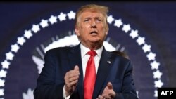 President Trump applauds as he attends Independence Day events at Mount Rushmore in Keystone, South Dakota, July 3, 2020. 