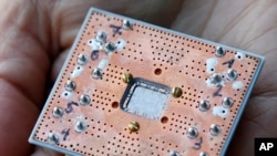 This Feb. 27, 2018, photo shows a seven cubit quantum device is seen at the IBM Thomas J. Watson Research Center in Yorktown Heights, New York.