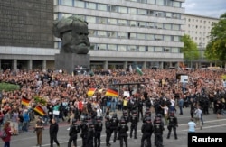 Right-wing supporters protest against foreigners after a German man was stabbed last weekend in Chemnitz, Germany, Aug. 27, 2018.