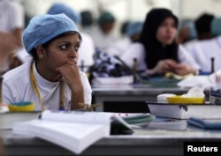 Students work on their lessons at the former dental school of Savita Halappanavar in Belgaum in the southern Indian state of Karnatakam, November 16, 2012.
