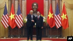 President Donald Trump and Vietnamese President Tran Dai Quang pose for photographers at the Presidential Palace, Nov. 12, 2017, in Hanoi, Vietnam. Trump is on a five country trip through Asia traveling to Japan, South Korea, China, Vietnam and the Philippines.