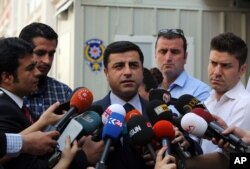 Pro-Kurdish Peoples' Democracy Party leader Selahattin Demirtas speaks to the media about Turkey's airstrikes against Kurdish rebel bases in Iraq, in Ankara, Turkey, July 27, 2015.