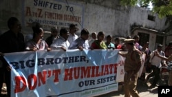 A police officer stops a group of Indians protesting against the arrest of Devyani Khobragade, an Indian consular officer in New York, outside the U.S consulate in Hyderabad, India, Dec. 16, 2013.