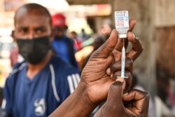 FILE - A health official prepares the Moderna Covid-19 vaccine during a mass Covid-19 vaccination drive in Nairobi, Kenya, Sep. 17, 2021.