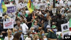 People attend a demonstration in Paris on July 5, 2020 in support of Algeria's Hirak key protest movement as Algeria celebrates today the anniversary of its 1962 independence from France.