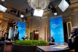President Joe Biden, center, Secretary of State Antony Blinken, left, and Special Presidential Envoy for Climate John Kerry, right, listen during the virtual Leaders Summit on Climate.