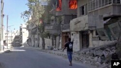 This handout frame grab from video provided by Doctors Without Borders, shows a house on fire in Aleppo, Syria, Oct. 5, 2016.