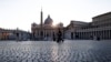 Police officers patrol an empty St. Peter's Square at the Vatican, Friday, April 10, 2020. Pope Francis began the Good Friday service at the Vatican with the Passion of Christ Mass and hours later will preside over the traditional Way of the Cross…