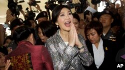 Thailand's former Prime Minister Yingluck Shinawatra, center, leaves parliament in Bangkok, Jan. 22, 2015.