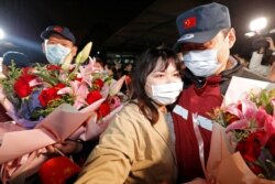 A medical team member hugs a family member at the end of a 14-day quarantine following the team's return from Wuhan, the epicentre of China's coronavirus disease (COVID-19) outbreak, at a hospital in Shanghai, China April 1, 2020. Picture taken…