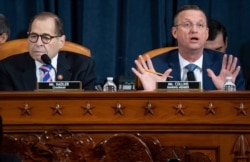 House Judiciary Committee Chairman Rep. Jerrold Nadler, D-N.Y., left, listens as ranking member Rep. Doug Collins, R-Ga., speaks during a hearing before the House Judiciary Committee on the constitutional grounds for impeachment