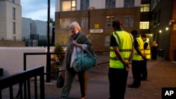 Residents are evacuated from the Taplow residential tower block on the Chalcots Estate, in the borough of Camden, north London, June 23, 2017. The evacuation, for safety concerns, followed a devastating fire that killed 79 people in a west London high-rise. 