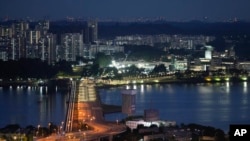 FILE - The Johor-Singapore Causeway lies empty in Johor Bahru, Malaysia, on Nov. 28, 2021. The urgency for Southeast Asian nations to switch to clean energy to combat climate change is reinvigorating a 20-year-old plan for the region to share power. (AP Photo/Vincent Thian, File)